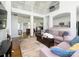Spacious living room featuring hardwood floors, soaring ceilings, and an open layout to the kitchen and foyer at 125 Mariner Pointe Ln, Mooresville, NC 28117