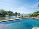 Backyard pool with a lake view surrounded by waterfront homes with a tree line at 125 Mariner Pointe Ln, Mooresville, NC 28117