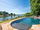 Backyard pool overlooking a serene lake with waterfront homes and tree-lined shores at 125 Mariner Pointe Ln, Mooresville, NC 28117