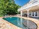 Inviting backyard pool with a sunning area, deck and covered outdoor entertaining space at 125 Mariner Pointe Ln, Mooresville, NC 28117