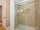 Tiled shower with sliding glass doors at 125 Mariner Pointe Ln, Mooresville, NC 28117