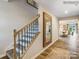 Hallway with wood floors, staircase with carpeted steps, and an entryway mirror at 134 Wheeler Trl, Statesville, NC 28625