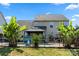 The backyard offers a gorgeous swimming pool with beautiful palms and green grass at 1403 Rosemont Dr, Fort Mill, SC 29707