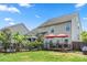 Well-maintained backyard features mature landscaping, patio, deck and partial view of swimming pool at 1403 Rosemont Dr, Fort Mill, SC 29707