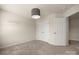A neutral bedroom featuring carpet, a ceiling light, two bright windows, and two closets at 1403 Rosemont Dr, Fort Mill, SC 29707