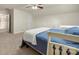 A cozy bedroom featuring carpet, a ceiling fan, and two bright windows at 1403 Rosemont Dr, Fort Mill, SC 29707