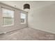 Neutral bedroom with carpet, a ceiling light, and a bright window at 1403 Rosemont Dr, Fort Mill, SC 29707