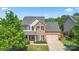 Charming two-story home featuring brick and vinyl siding, a well-maintained lawn, and mature trees at 1403 Rosemont Dr, Fort Mill, SC 29707