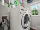 Bright laundry room featuring a modern washer and dryer set, with ample storage space at 1403 Rosemont Dr, Fort Mill, SC 29707