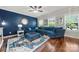 Living room with a large blue sectional sofa, patterned rug, and ample natural light at 1403 Rosemont Dr, Fort Mill, SC 29707