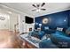 Comfortable living room showcasing a blue sectional sofa, fireplace, and hardwood floors at 1403 Rosemont Dr, Fort Mill, SC 29707