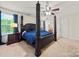 Spacious main bedroom featuring a four-post bed, ceiling fan and ensuite bathroom at 1403 Rosemont Dr, Fort Mill, SC 29707