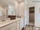 Elegant main bathroom features double sinks, a large mirror, and access to the closet at 141 Wheeler Trl, Statesville, NC 28625