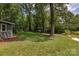 Expansive backyard with mature trees, a lush lawn, and ample space for outdoor recreation at 1427 Worcaster Pl, Charlotte, NC 28211