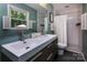 Modern bathroom featuring a double sink vanity, subway tile shower, and ample natural light at 1427 Worcaster Pl, Charlotte, NC 28211