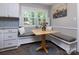 Cozy breakfast nook with built-in seating and large windows at 1427 Worcaster Pl, Charlotte, NC 28211