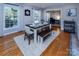 Bright dining room featuring hardwood floors, white trim, and a dining table with bench seating at 1427 Worcaster Pl, Charlotte, NC 28211