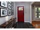 Stylish foyer featuring a red front door and decorative console table at 1427 Worcaster Pl, Charlotte, NC 28211