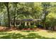 Charming one-story home with a well-manicured lawn and mature trees at 1427 Worcaster Pl, Charlotte, NC 28211