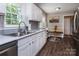 Modern kitchen featuring stainless steel appliances and white cabinets with breakfast nook at 1427 Worcaster Pl, Charlotte, NC 28211