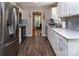 Bright kitchen with stainless steel appliances, subway tile backsplash, and hardwood floors at 1427 Worcaster Pl, Charlotte, NC 28211