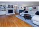 Spacious living room with hardwood floors, a fireplace, and abundant natural light at 1427 Worcaster Pl, Charlotte, NC 28211