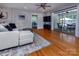 Open-concept living room with sliding glass doors to outdoor space and hardwood floors at 1427 Worcaster Pl, Charlotte, NC 28211