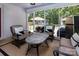 Screened patio with comfortable seating, a stone table, and views of the backyard at 1427 Worcaster Pl, Charlotte, NC 28211