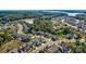 Aerial view of a lovely neighborhood with mature landscaping, and community lake in the distance at 15108 Montage Ln, Charlotte, NC 28278