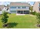 Backyard featuring screened-in porch, patio, lush green lawn, and view of surrounding neighborhood at 15108 Montage Ln, Charlotte, NC 28278