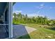 Backyard with screened in porch area, stone patio, and wooded views at 15108 Montage Ln, Charlotte, NC 28278