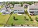 Expansive backyard featuring a covered patio, lush lawn, and privacy fencing for outdoor enjoyment at 15108 Montage Ln, Charlotte, NC 28278