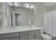 Double sink bathroom features gray vanity with bright countertop, large mirror and shower at 15108 Montage Ln, Charlotte, NC 28278