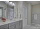 Elegant bathroom features gray vanity, quartz countertop, and a clear view of the glass shower at 15108 Montage Ln, Charlotte, NC 28278