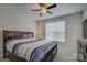 Bedroom featuring a ceiling fan, queen-sized bed, and a chest of drawers at 15108 Montage Ln, Charlotte, NC 28278