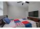 Bedroom boasts a modern television and a colorful quilt on the cozy bed at 15108 Montage Ln, Charlotte, NC 28278