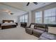 Spacious main bedroom suite featuring seating area, large windows, and ceiling fan at 15108 Montage Ln, Charlotte, NC 28278