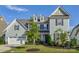 Charming two-story home showcasing a manicured lawn, attached garage, and a welcoming facade with classic architectural details at 15108 Montage Ln, Charlotte, NC 28278