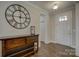 Elegant foyer showcasing hardwood floors, a decorative console table with a large clock, and a welcoming entrance at 15108 Montage Ln, Charlotte, NC 28278
