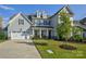 Charming two-story home with a well-maintained lawn, attached garage, and inviting covered porch at 15108 Montage Ln, Charlotte, NC 28278