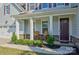 Inviting front porch featuring rocking chairs, manicured shrubbery, and stone accents, perfect for relaxing outdoors at 15108 Montage Ln, Charlotte, NC 28278