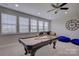 Game room featuring a pool table, fan and ample seating with natural light at 15108 Montage Ln, Charlotte, NC 28278