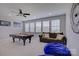 Spacious game room featuring a pool table, a brown sofa, and natural light at 15108 Montage Ln, Charlotte, NC 28278