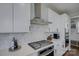 Close-up of a modern, eat-in kitchen features stainless steel appliances and range hood at 15108 Montage Ln, Charlotte, NC 28278