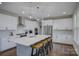 Bright, modern kitchen features an oversized island with seating, stainless steel appliances, and marble backsplash at 15108 Montage Ln, Charlotte, NC 28278