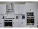 Bright kitchen features stainless steel appliances and a range hood at 15108 Montage Ln, Charlotte, NC 28278