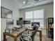 Office area with hardwood floors and natural light, featuring a large computer setup at 15108 Montage Ln, Charlotte, NC 28278