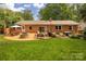 Lovely backyard with a stone fire pit and lots of room for outdoor entertaining at 1514 Wensley Dr, Charlotte, NC 28210