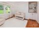 Cozy Bedroom with a crib, built-in shelves, and a window at 1514 Wensley Dr, Charlotte, NC 28210
