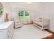 Charming Bedroom with a crib, armchair, and light-filled windows at 1514 Wensley Dr, Charlotte, NC 28210